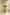 Glass vase with artificial flowers on a beige background