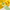 Glass of lemonade with ice and green straw on a yellow background