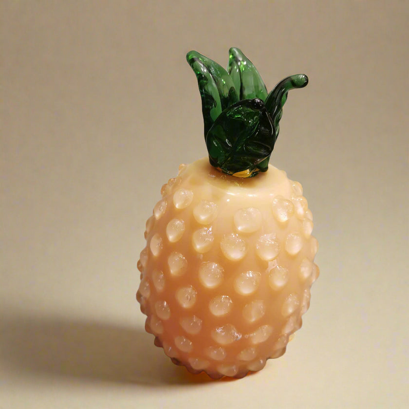 Decorative pineapple-shaped object on a beige background