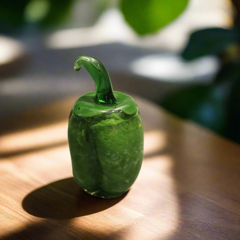 Handblown glass bell pepper decoration with a natural green finish.