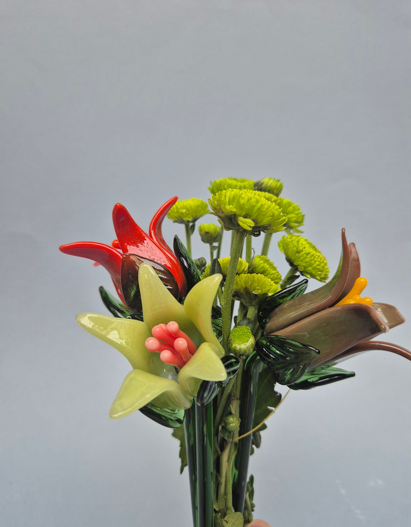Colorful ceramic flower arrangement on a gray background