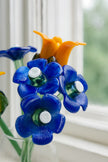 Artificial flowers made from plastic bottles with blue and orange colors.