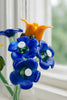 Artificial flowers made from plastic bottles with blue and orange colors.