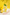 Glass of lemonade with lemon slices and a straw on a yellow background