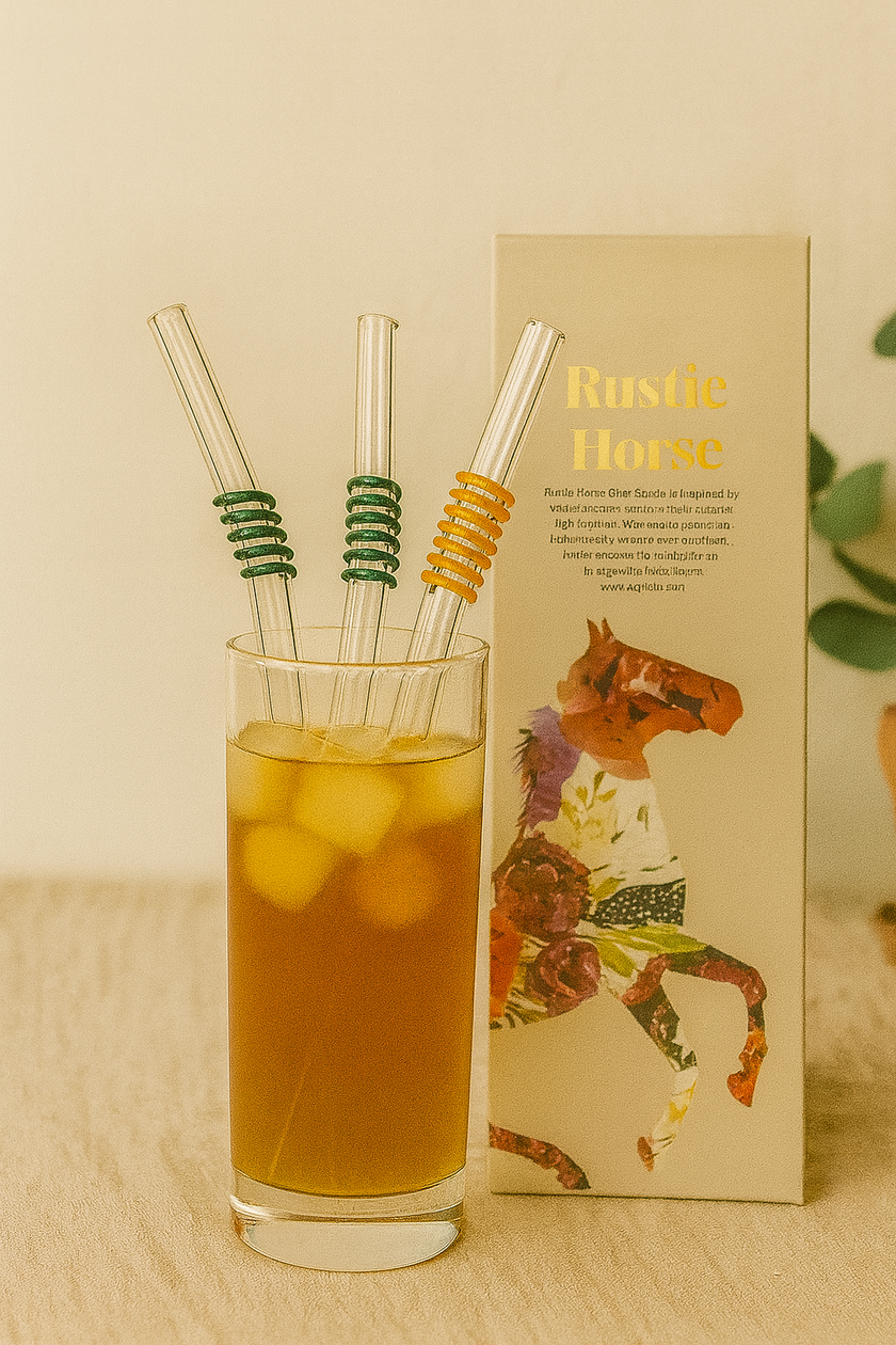 Glass of iced tea with straws and a box labeled 'Rustic Home' on a wooden surface.